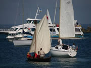 faering sailing past yachts, Brittany